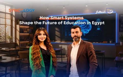 How Smart Systems Shape the Future of Education in Egypt 1 A man and a woman standing in a modern classroom next to text reading how smart systems shape the Future of Education in Egypt.