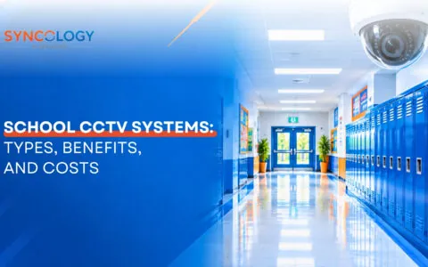 A ceiling-mounted dome security camera monitoring a bright, modern school hallway lined with blue lockers, illustrating School CCTV Systems.